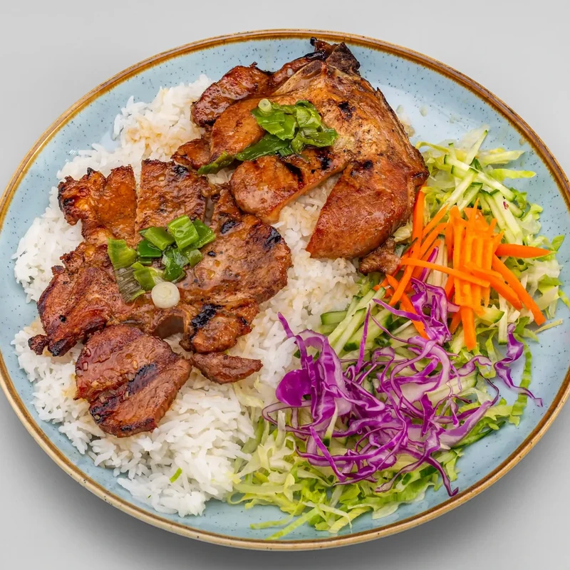 Pork Chops on Rice with lettuce, cucumber, pickled carrots and cabbage at Bon Vietnamese Cuisine, Redstone, Calgary